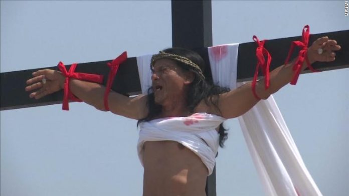 Ruben Enaje grimaces in pain during his cruxifixion in San Pedro Cutud, Philippines.