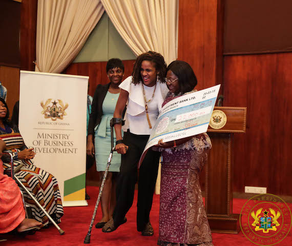 Chief of Staff, Akosua Frema Opare Osei presenting a cheque to one of the beneficiaries