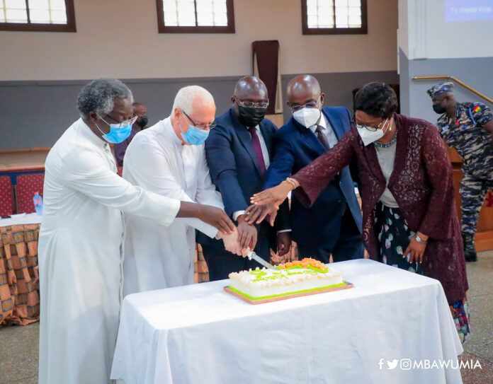 Dr Mahamudu Bawumia and others cutting the Soup Kitchen anniversary cake