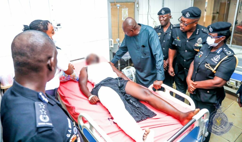 Ambrose Dery at the bedside of the injured police officer at the hospital