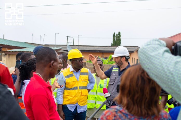 Kojo Oppong Nkrumah, minister of works and housing (in yellow vest) interacting with officials during an inspection of ongoing dredging works on the Odaw River Basin.