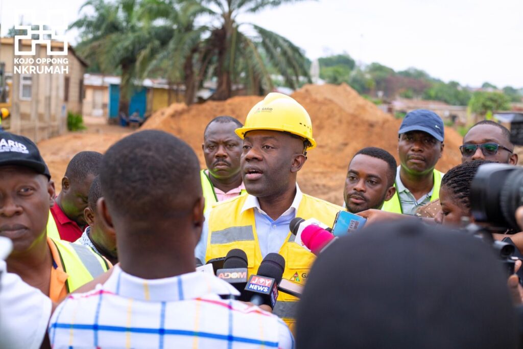 Kojo Oppong Nkrumah, minister of works and housing (in yellow vest) interacting with the media during an inspection of ongoing dredging works on the Odaw River Basin.